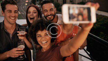 A group of people taking a selfie.
