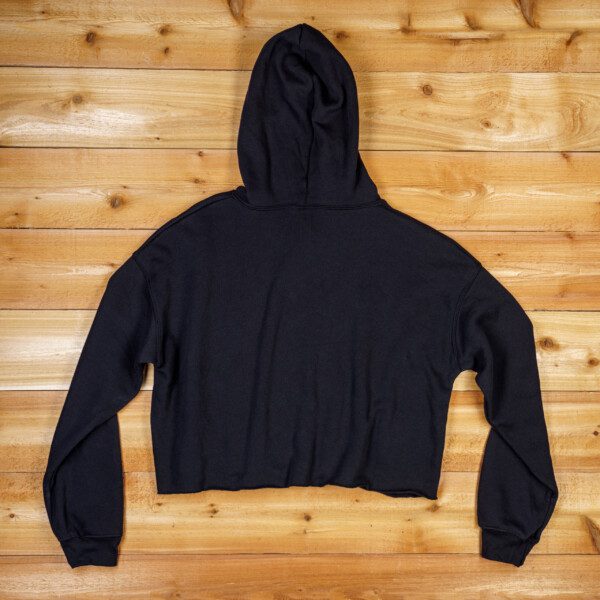A WRS Black Cropped Hoodie on a wooden floor.