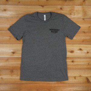 Whiskey river saloon T Shirt in Dark Gray color on the table