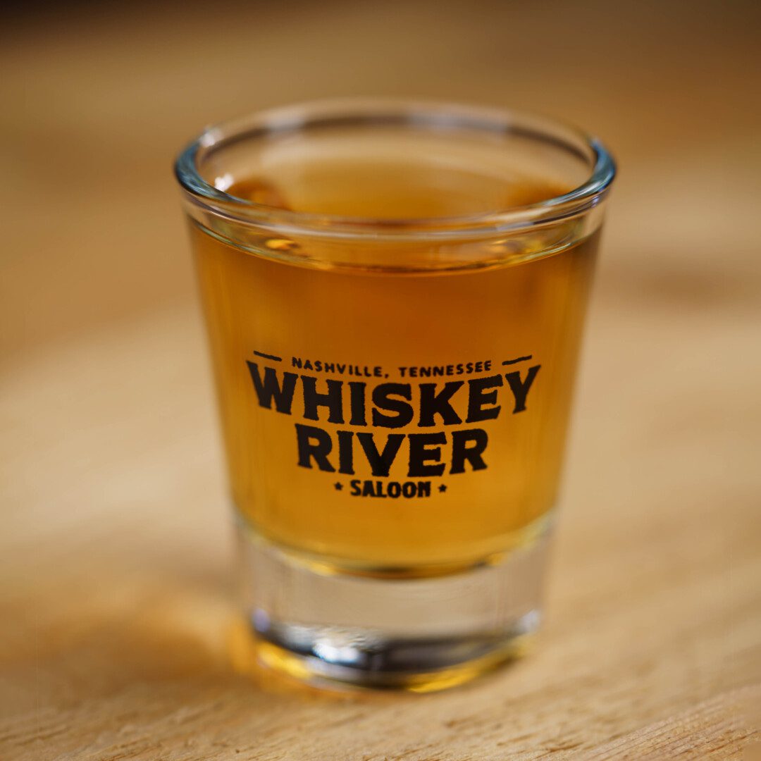 Focused view of Whiskey river saloon Shot Glass