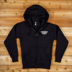 Whiskey river saloon Zip Up Hoodie in Black color and a brown background