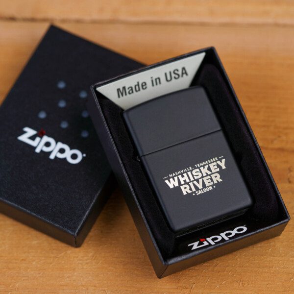 Whiskey river saloon Zippo Lighter in black color on a wooden table