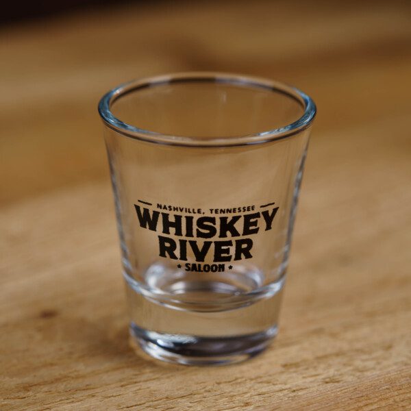 Focused view of Whiskey river saloon Shot Glass