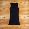 A black tank top is on the floor.