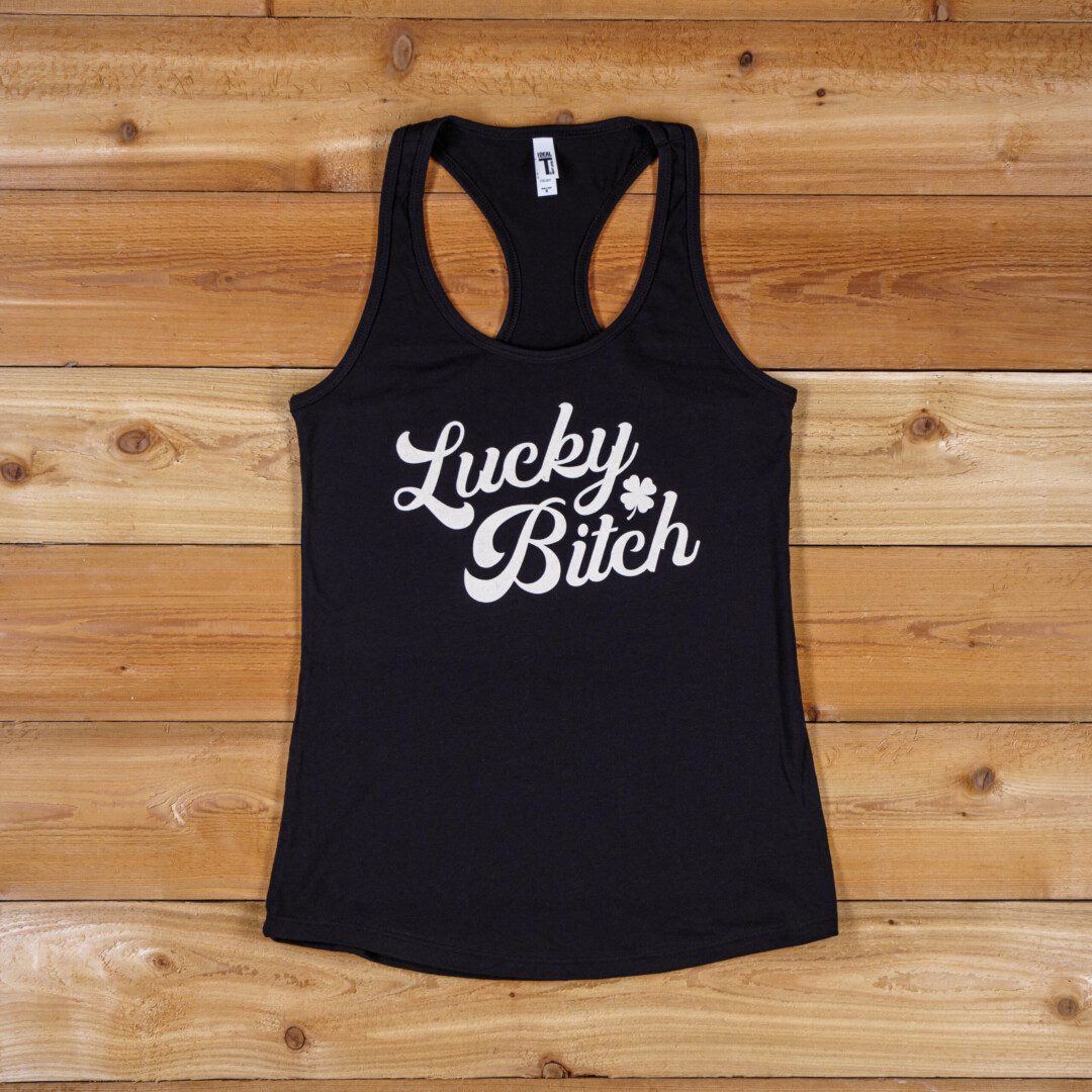 A black tank top with the words lucky bitch written on it.